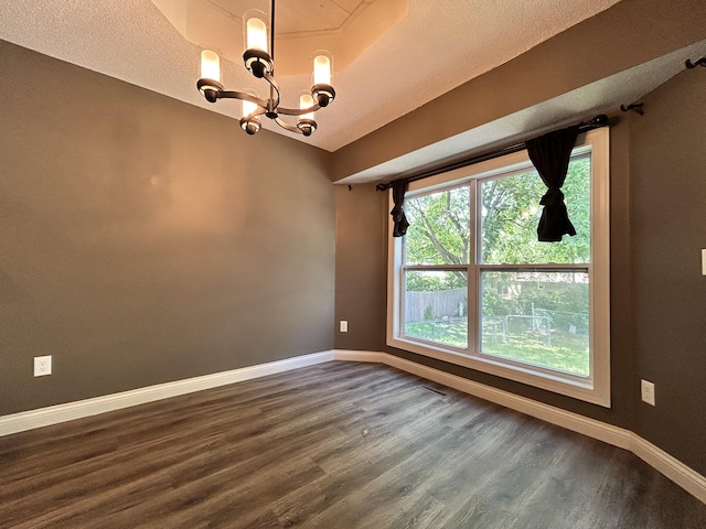 3223 W Primrose St, Springfield, MO 65807 - empty room with dark wood finished floors, a chandelier, and baseboards