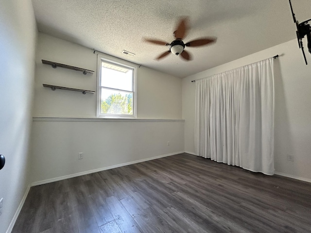 3223 W Primrose St, Springfield, MO 65807 - unfurnished room featuring a ceiling fan, dark wood-type flooring, a textured ceiling, and baseboards