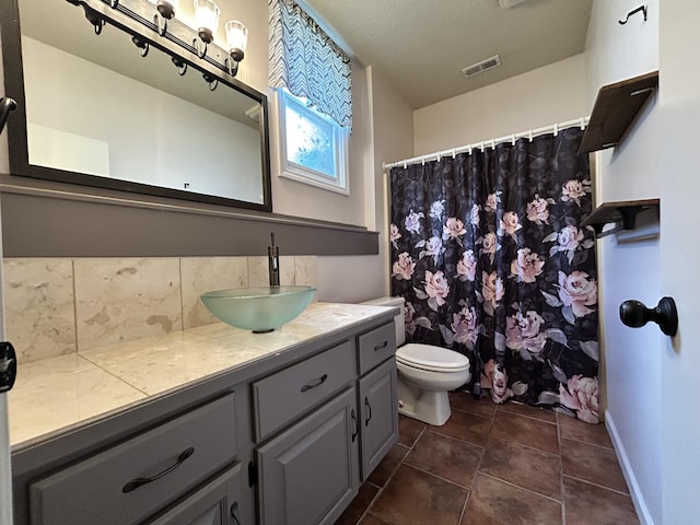 3223 W Primrose St, Springfield, MO 65807 - bathroom with decorative backsplash, vanity, toilet, tile patterned floors, and curtained shower
