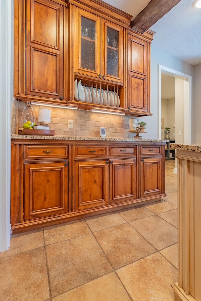 853 E Grafton Dr, Nixa, MO 65714 - kitchen with brown cabinetry, decorative backsplash, and beam ceiling