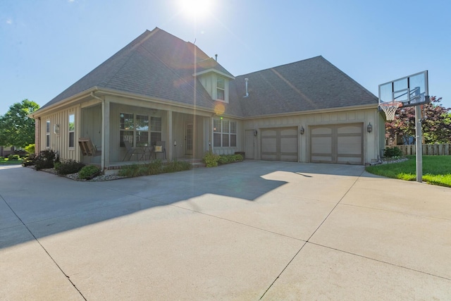 853 E Grafton Dr, Nixa, MO 65714 - view of front facade featuring covered porch, driveway, an attached garage, board and batten siding, and roof with shingles