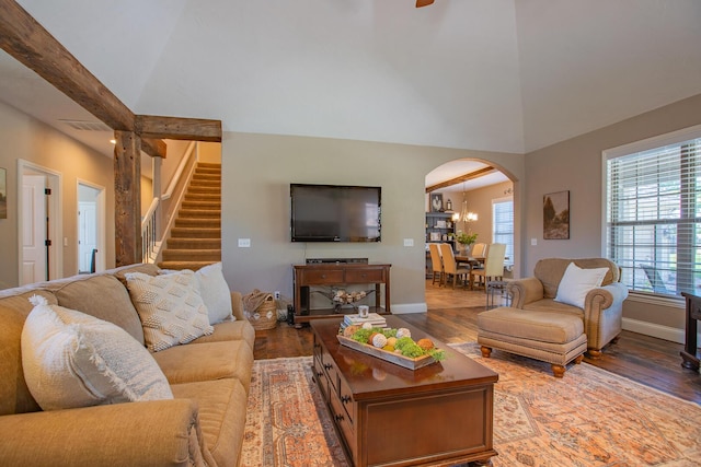 853 E Grafton Dr, Nixa, MO 65714 - living area featuring wood finished floors, arched walkways, high vaulted ceiling, baseboards, and stairs