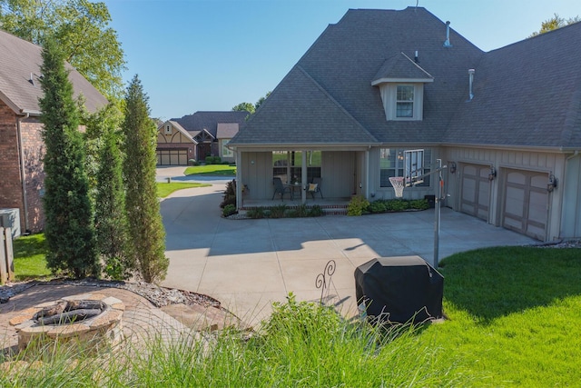 853 E Grafton Dr, Nixa, MO 65714 - view of front of property featuring driveway, a porch, board and batten siding, roof with shingles, and a fire pit
