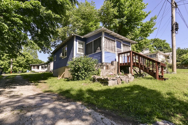 123 Recreation Ave, Rockaway Beach, MO 65740 - view of side of property featuring stairs and a lawn