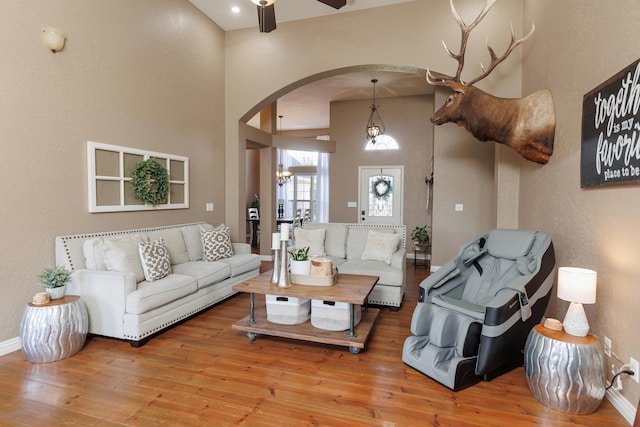 1415 Woodland Rd, Marshfield, MO 65706 - living room featuring arched walkways, hardwood / wood-style flooring, baseboards, ceiling fan, and a textured wall