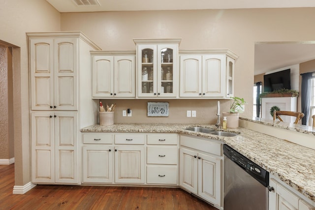 1415 Woodland Rd, Marshfield, MO 65706 - kitchen with stainless steel dishwasher, a sink, cream cabinetry, and dark wood-style floors