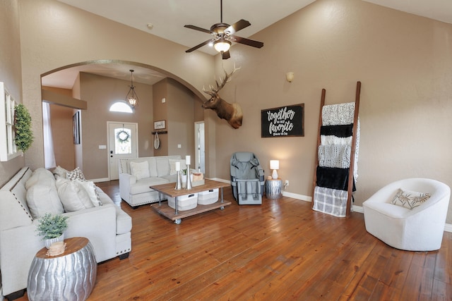 1415 Woodland Rd, Marshfield, MO 65706 - living area featuring arched walkways, a ceiling fan, hardwood / wood-style flooring, high vaulted ceiling, and baseboards