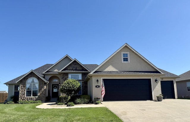 1415 Woodland Rd, Marshfield, MO 65706 - view of front of property with stucco siding, a garage, a front lawn, stone siding, and concrete driveway