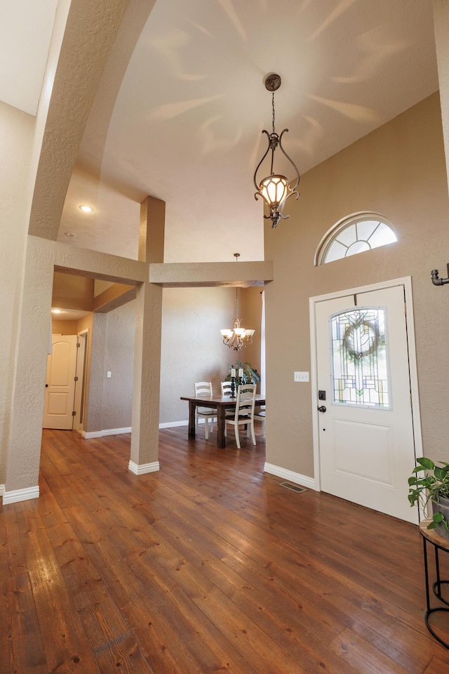 1415 Woodland Rd, Marshfield, MO 65706 - entryway featuring a chandelier, wood-type flooring, a towering ceiling, and baseboards