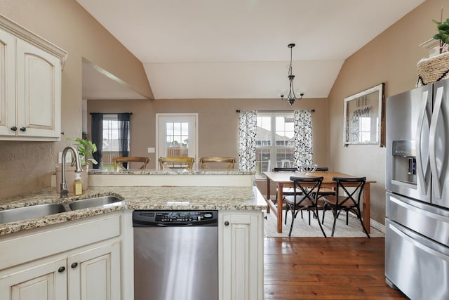1415 Woodland Rd, Marshfield, MO 65706 - kitchen featuring appliances with stainless steel finishes, lofted ceiling, a sink, dark wood-style flooring, and a peninsula