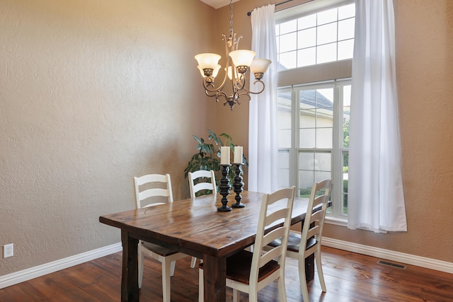 1415 Woodland Rd, Marshfield, MO 65706 - dining room featuring wood finished floors, a chandelier, a textured wall, and baseboards
