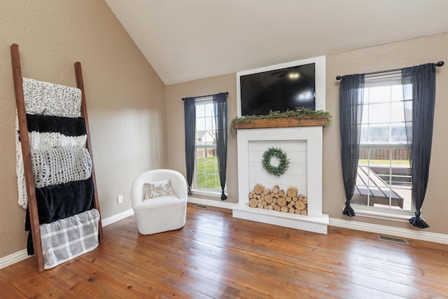 1415 Woodland Rd, Marshfield, MO 65706 - sitting room featuring vaulted ceiling, hardwood / wood-style flooring, baseboards, and a textured wall