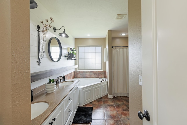 1415 Woodland Rd, Marshfield, MO 65706 - bathroom featuring double vanity and a bath