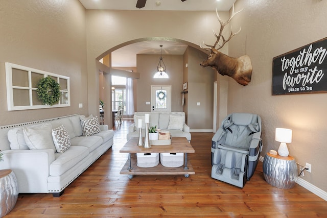 1415 Woodland Rd, Marshfield, MO 65706 - living area featuring arched walkways, ceiling fan, hardwood / wood-style flooring, a textured wall, and baseboards
