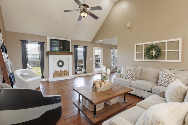 1415 Woodland Rd, Marshfield, MO 65706 - living room featuring high vaulted ceiling, ceiling fan, healthy amount of natural light, dark wood-style flooring, and baseboards