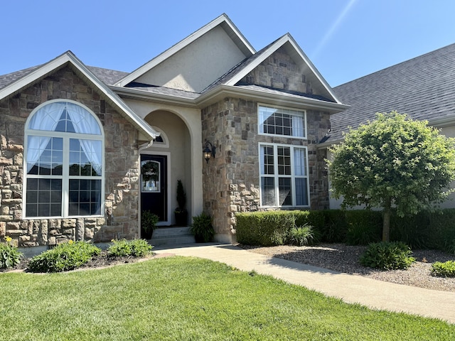 1415 Woodland Rd, Marshfield, MO 65706 - view of front of home featuring stone siding, a front lawn, stucco siding, and roof with shingles