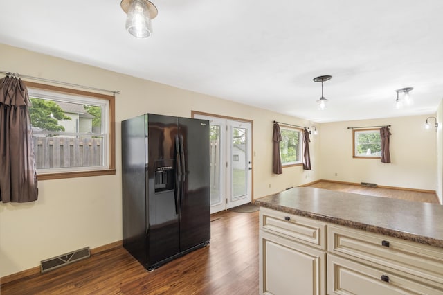 300 S High Ave, Ash Grove, MO 65604 - kitchen featuring black fridge, cream cabinetry, dark wood-type flooring, dark countertops, and baseboards