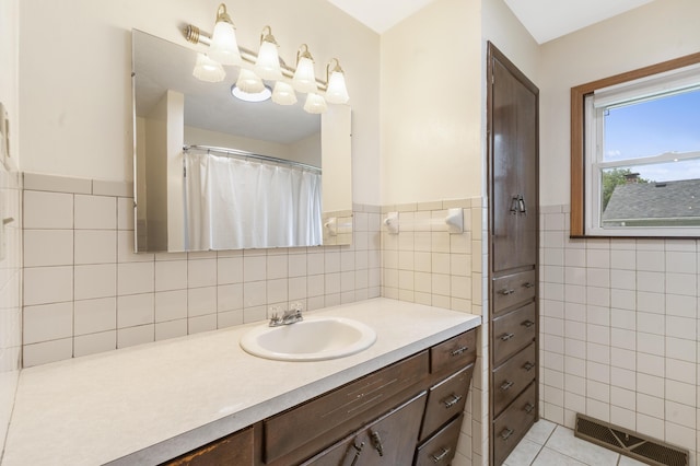 300 S High Ave, Ash Grove, MO 65604 - full bath with tile walls, vanity, a wainscoted wall, and tile patterned floors