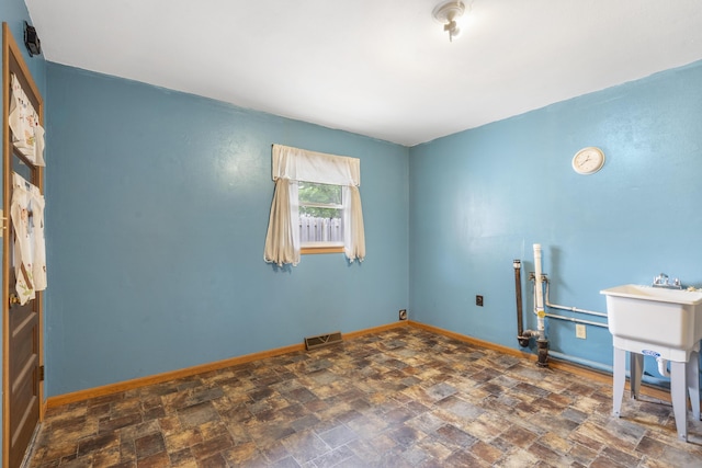 300 S High Ave, Ash Grove, MO 65604 - spare room with stone finish flooring and baseboards