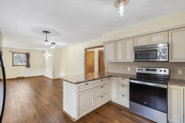 300 S High Ave, Ash Grove, MO 65604 - kitchen with stainless steel appliances, cream cabinetry, a peninsula, decorative backsplash, and dark wood finished floors