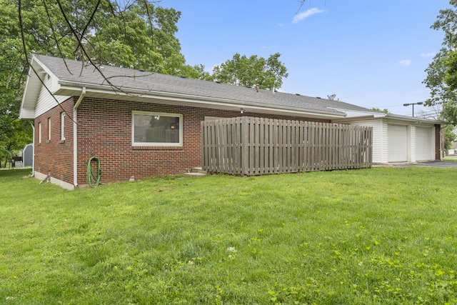 300 S High Ave, Ash Grove, MO 65604 - rear view of property with brick siding, a yard, and a garage