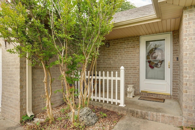 413 W Chestnut Rd, Nixa, MO 65714 - view of exterior entry with brick siding and a shingled roof