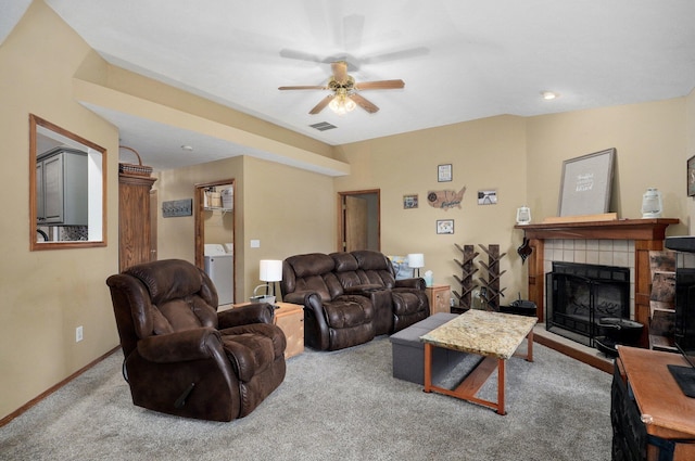 413 W Chestnut Rd, Nixa, MO 65714 - living room featuring a ceiling fan, washer / clothes dryer, carpet, a fireplace, and baseboards