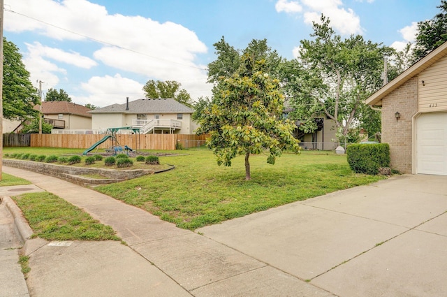 413 W Chestnut Rd, Nixa, MO 65714 - view of yard with a playground, concrete driveway, and a garage