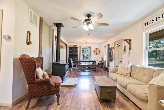 1899 State Highway Dd, Ava, MO 65608 - living area featuring a wood stove, dark wood-style flooring, a chandelier, and ceiling fan