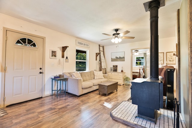 1899 State Highway Dd, Ava, MO 65608 - living area with a wood stove, ceiling fan, and wood finished floors