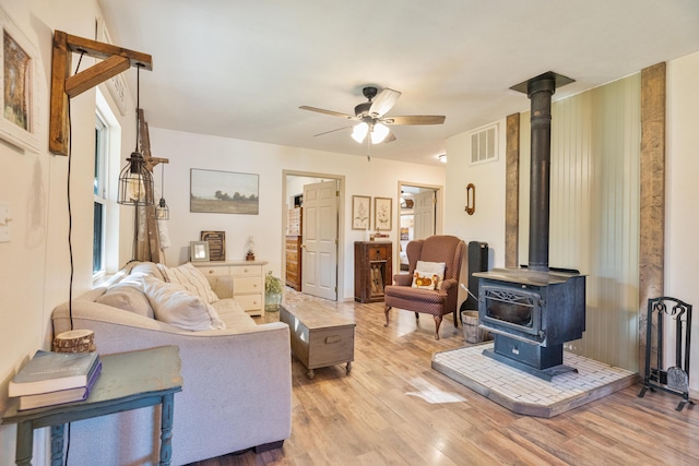 1899 State Highway Dd, Ava, MO 65608 - living area with a wood stove, light wood-style floors, and a ceiling fan