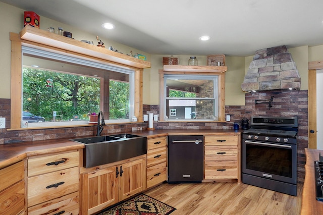 8403 Lawrence Unit 1040, La Russell, MO 64848 - kitchen with stainless steel gas range, a sink, custom exhaust hood, dishwashing machine, and backsplash