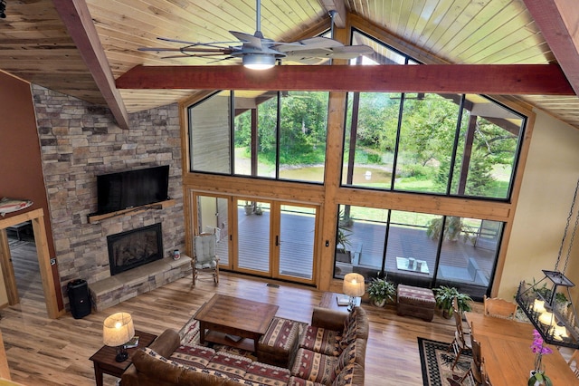 8403 Lawrence Unit 1040, La Russell, MO 64848 - living area featuring wood ceiling with exposed beams, a ceiling fan, a fireplace, wood finished floors, and high vaulted ceiling