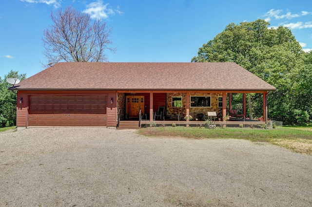 8403 Lawrence Unit 1040, La Russell, MO 64848 - view of front of home featuring a porch, a garage, driveway, and a shingled roof