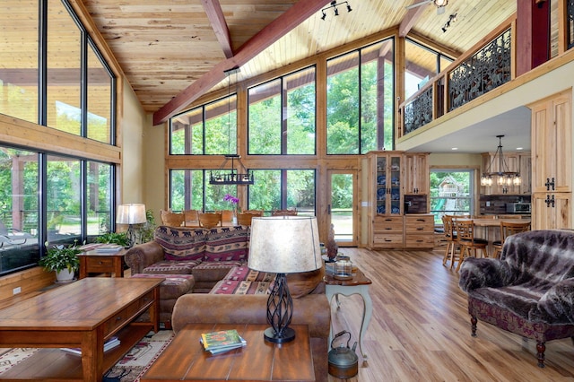 8403 Lawrence Unit 1040, La Russell, MO 64848 - living room featuring wood ceiling with exposed beams, high vaulted ceiling, light wood-style flooring, and a chandelier