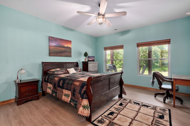 8403 Lawrence Unit 1040, La Russell, MO 64848 - bedroom with light wood-type flooring, baseboards, an office area, and a ceiling fan
