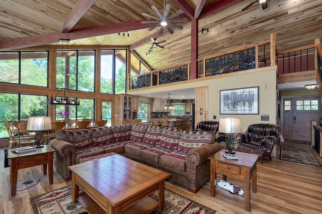 8403 Lawrence Unit 1040, La Russell, MO 64848 - living area featuring high vaulted ceiling, a ceiling fan, wood finished floors, healthy amount of natural light, and wood ceiling with exposed beams