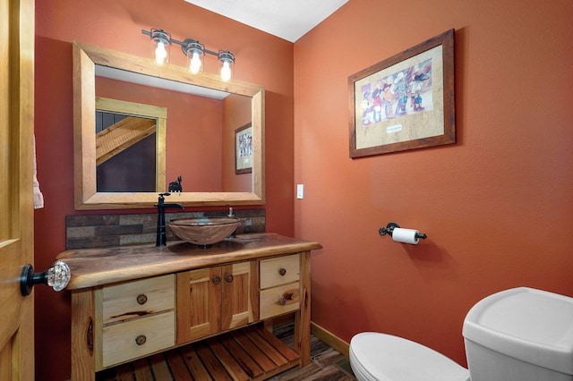 8403 Lawrence Unit 1040, La Russell, MO 64848 - bathroom with toilet, vanity, wood finished floors, and baseboards