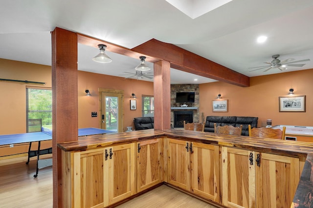 8403 Lawrence Unit 1040, La Russell, MO 64848 - kitchen featuring ceiling fan, light wood-style floors, open floor plan, wood counters, and beam ceiling