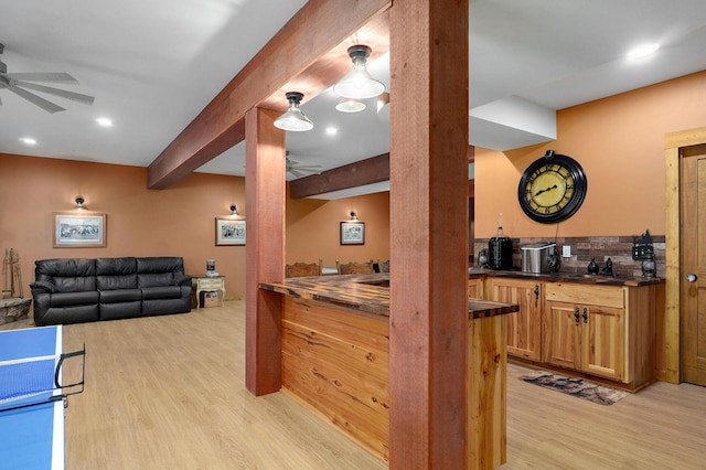 8403 Lawrence Unit 1040, La Russell, MO 64848 - bar with ceiling fan, light wood-type flooring, a sink, beamed ceiling, and tasteful backsplash