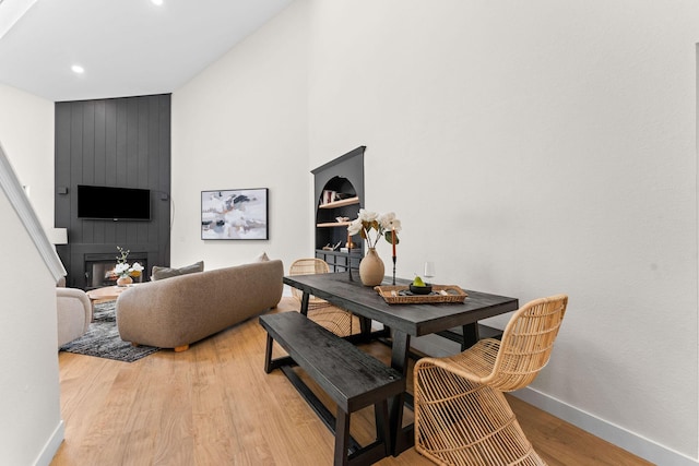280 Wimbledon Dr Unit 8, Branson, MO 65616 - dining room with baseboards, light wood-type flooring, recessed lighting, a fireplace, and a high ceiling