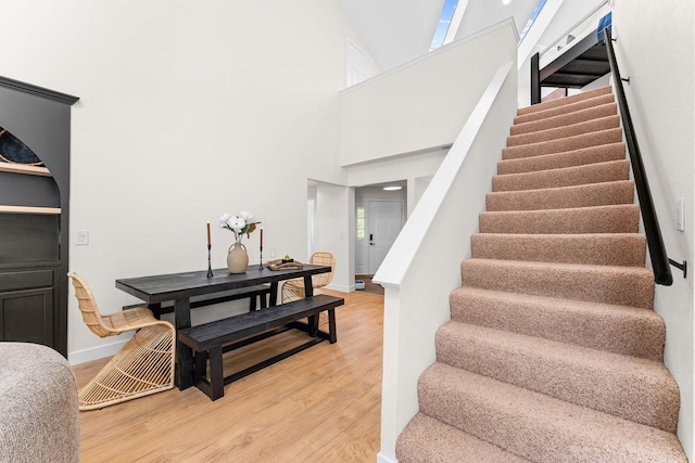 280 Wimbledon Dr Unit 8, Branson, MO 65616 - stairway with wood finished floors, baseboards, and a towering ceiling