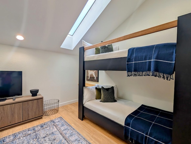 280 Wimbledon Dr Unit 8, Branson, MO 65616 - bedroom featuring a skylight, lofted ceiling, wood finished floors, and baseboards