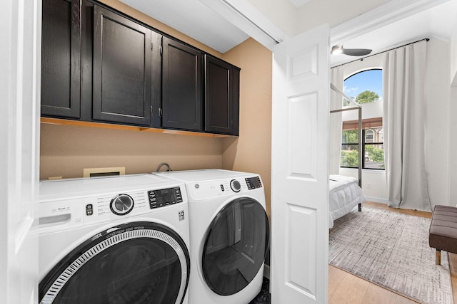 280 Wimbledon Dr Unit 8, Branson, MO 65616 - washroom with cabinet space, washing machine and dryer, and light wood-style floors