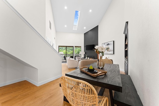 280 Wimbledon Dr Unit 8, Branson, MO 65616 - dining space with a high ceiling, a skylight, baseboards, light wood-style floors, and recessed lighting