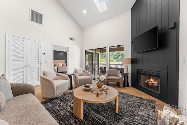 280 Wimbledon Dr Unit 8, Branson, MO 65616 - living area featuring high vaulted ceiling, a skylight, a large fireplace, and wood finished floors