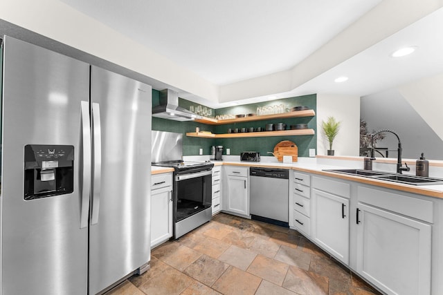 280 Wimbledon Dr Unit 8, Branson, MO 65616 - kitchen featuring stainless steel appliances, a sink, wall chimney range hood, open shelves, and light stone finish flooring