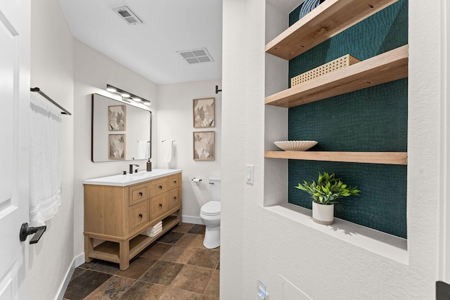 280 Wimbledon Dr Unit 8, Branson, MO 65616 - bathroom with vanity, toilet, baseboards, and stone finish floors