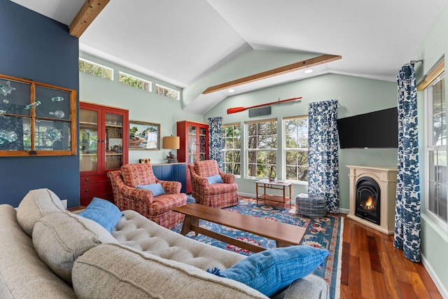27841 Old Pace Ln, Shell Knob, MO 65747 - living room featuring wood finished floors, lofted ceiling, plenty of natural light, a warm lit fireplace, and baseboards