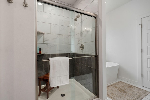 735 N Fox Hill Cir, Nixa, MO 65714 - bathroom featuring a stall shower, a freestanding tub, and baseboards